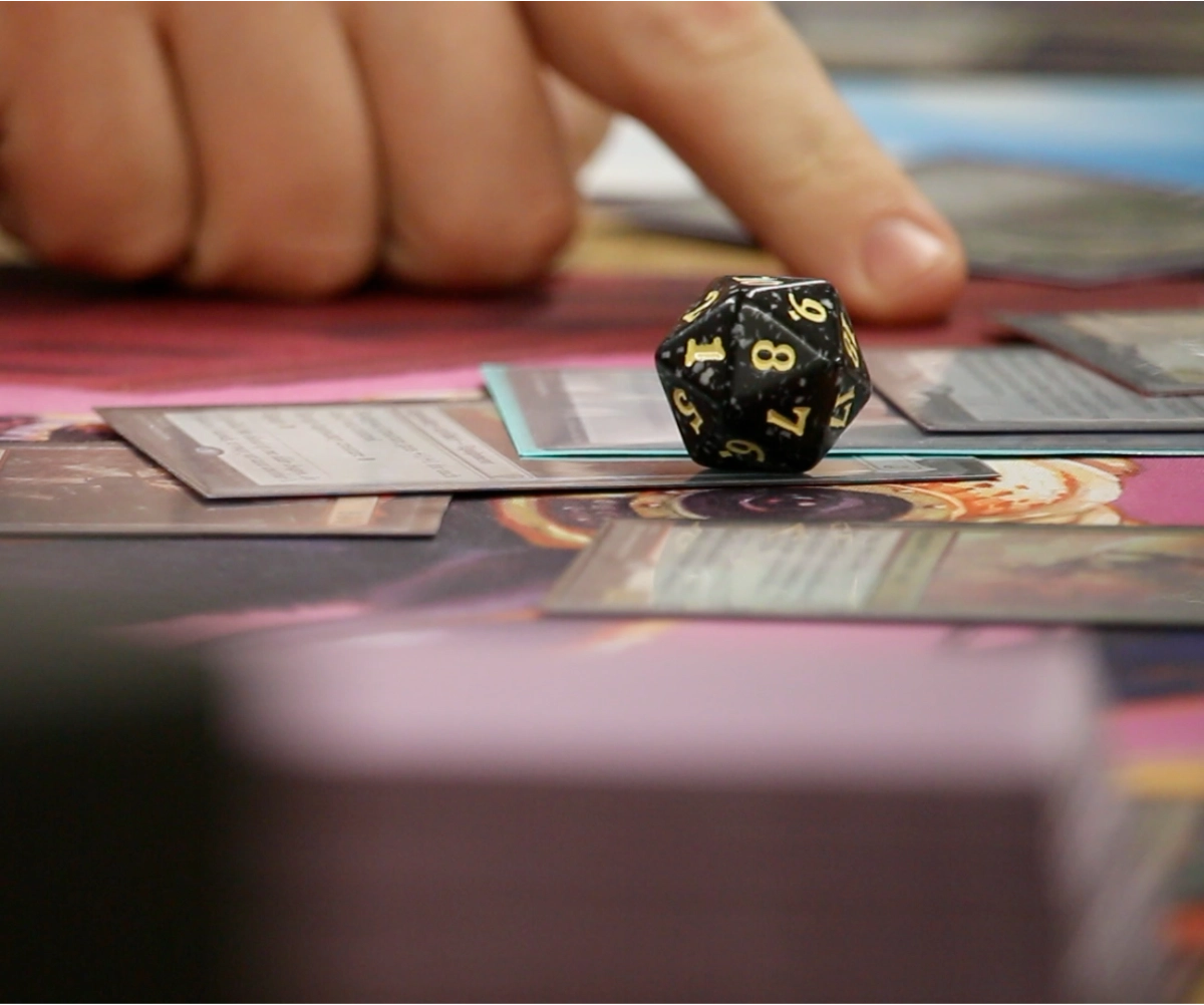 A dice block and cards on a table